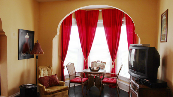 Large high archways leading to table in bay window
